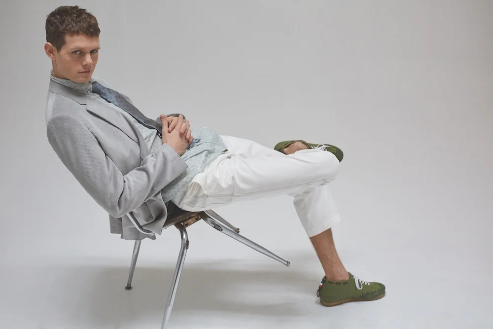Blazer, shirt, & tie BILLY REID. Pants ($120) TOPMAN. Sneakers ($395) HEIRLOOM.
