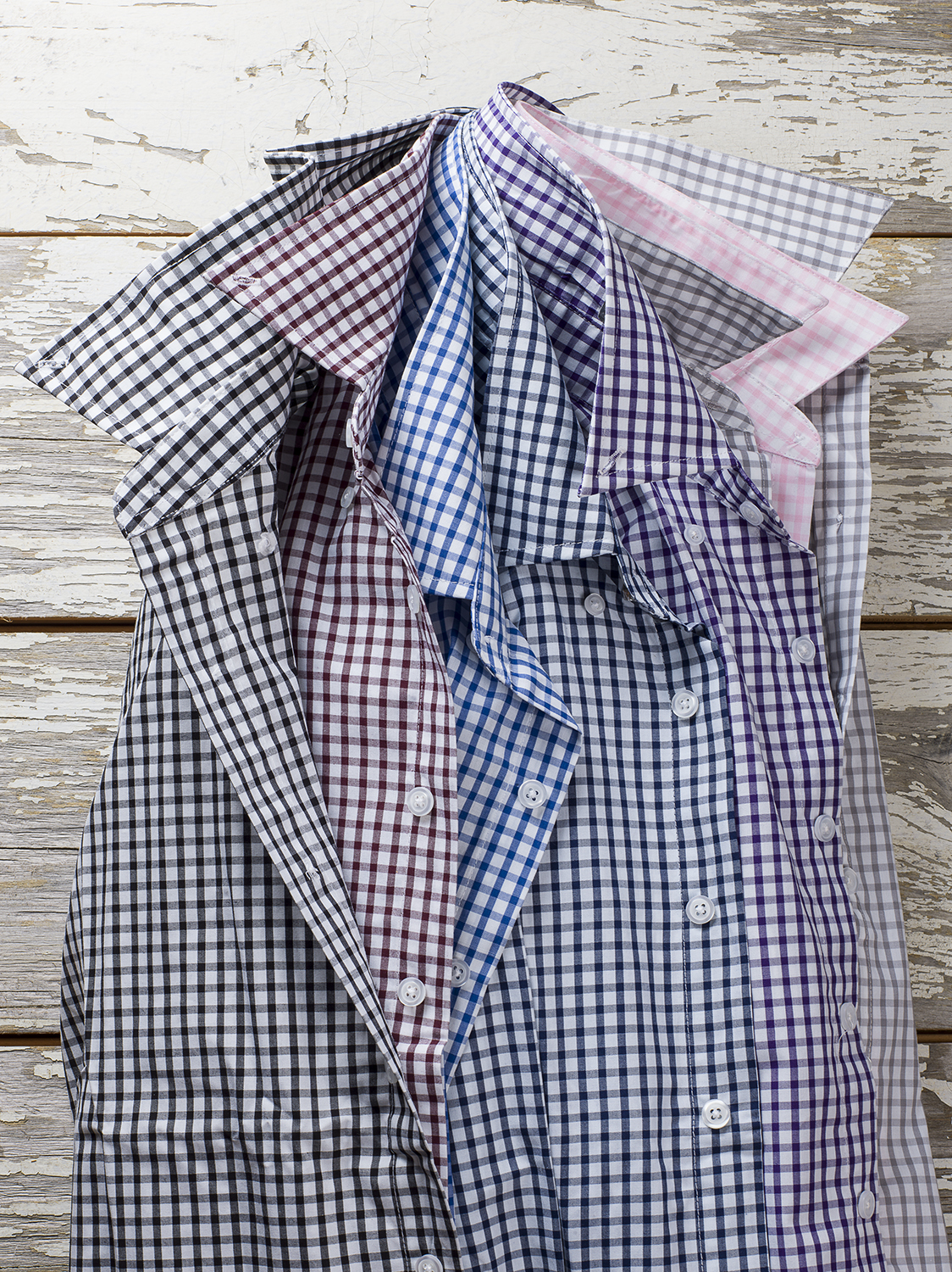  Mens collared shirts against distressed white wood wall. 