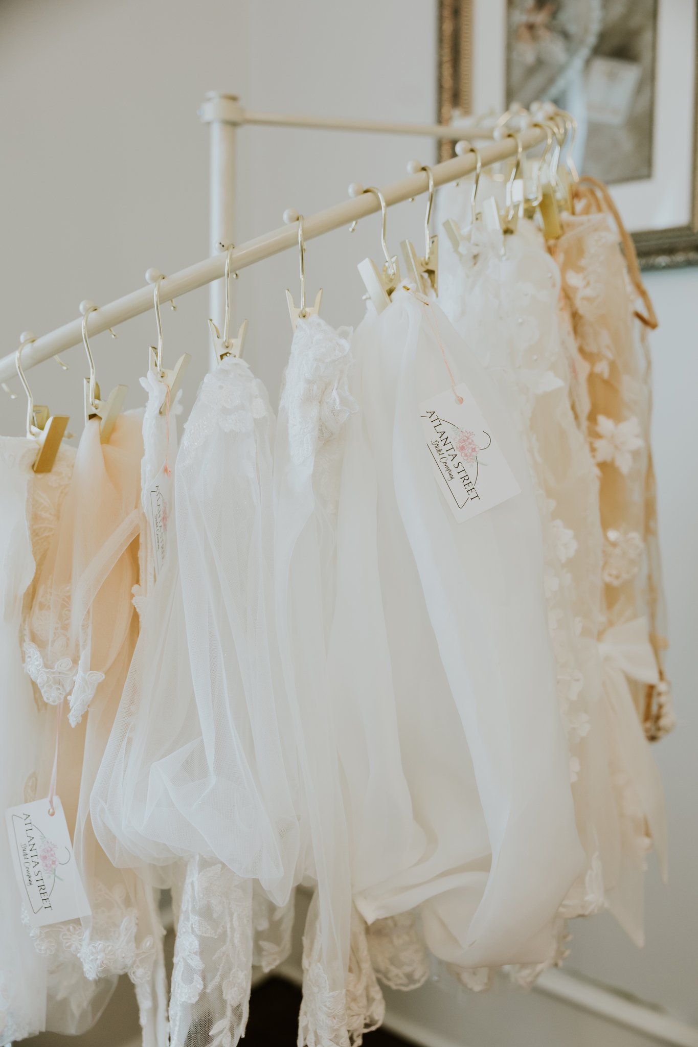 Bridal veils and accessories hanging on rack inside Atlanta Street Bridal boutique showroom.