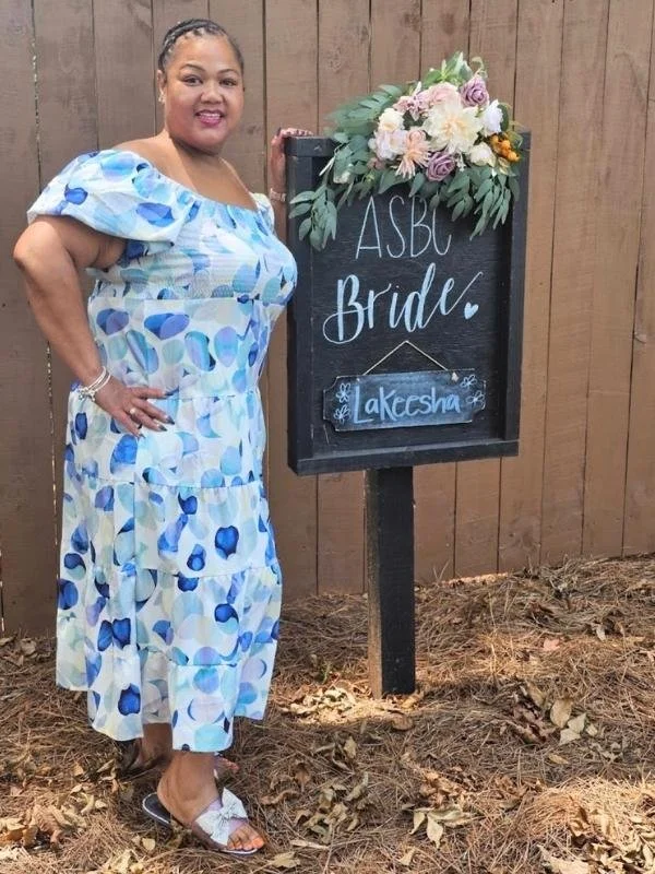 Bride standing with a personalized parking sign.jpg