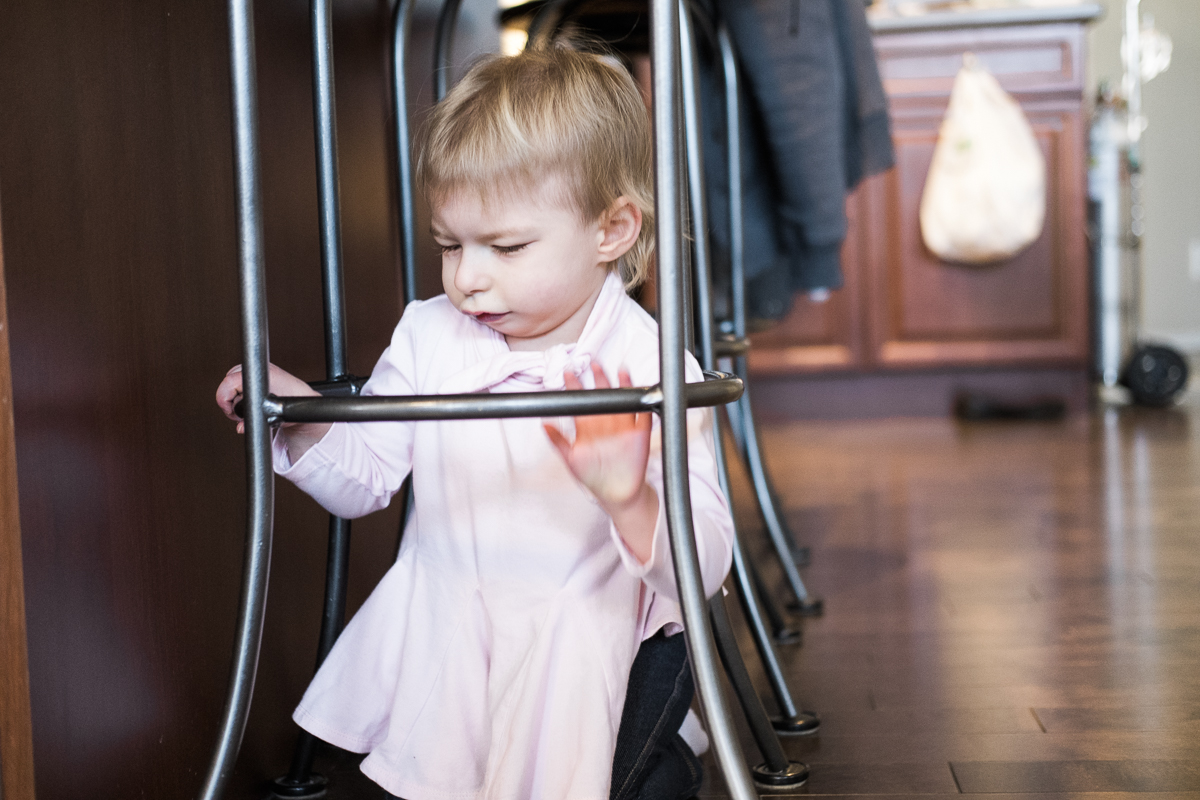 Hayden crawling under the kitchen stools.. playing keep away from her dad. 