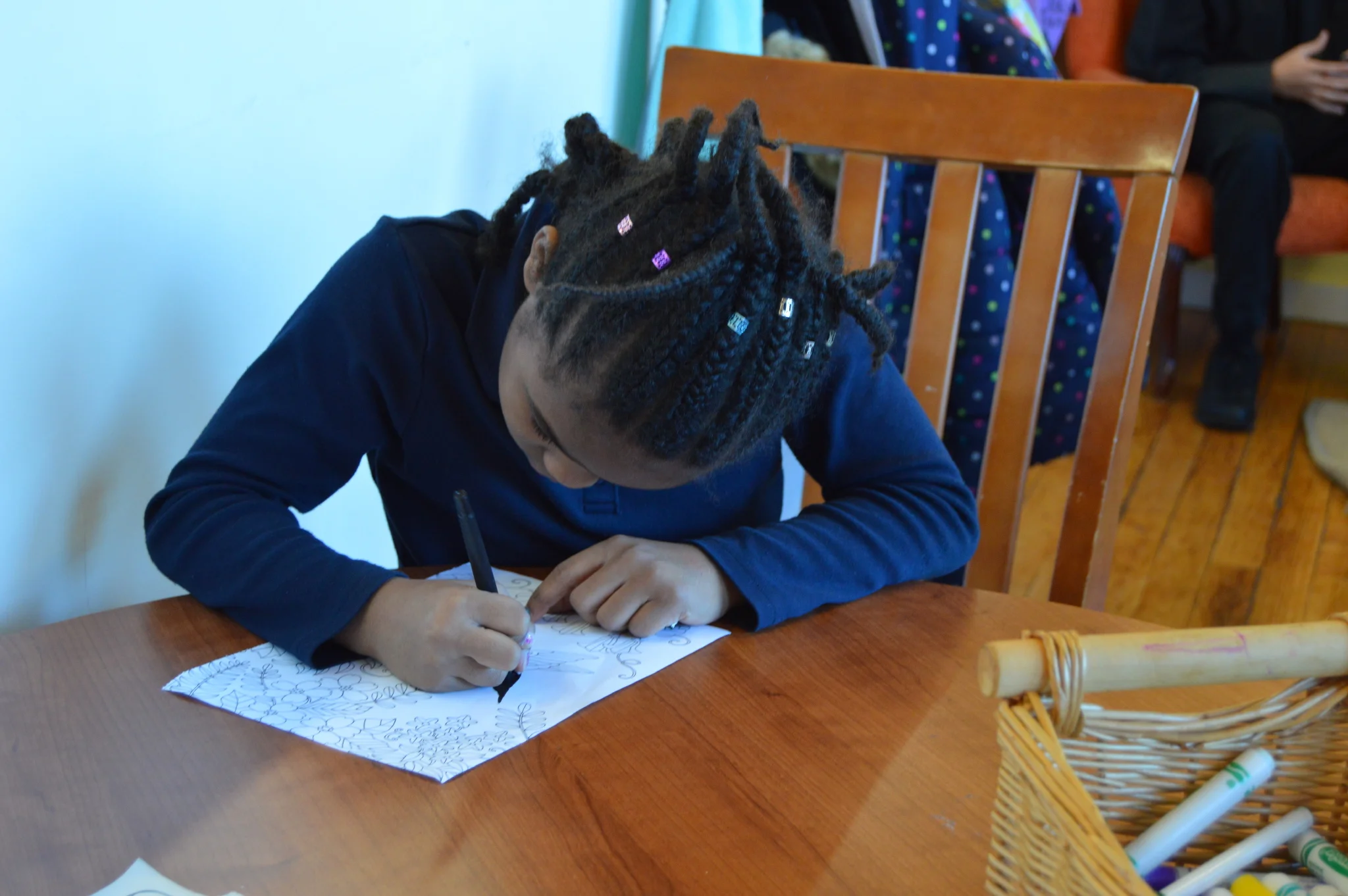 Laura coloring while waiting for her lesson time