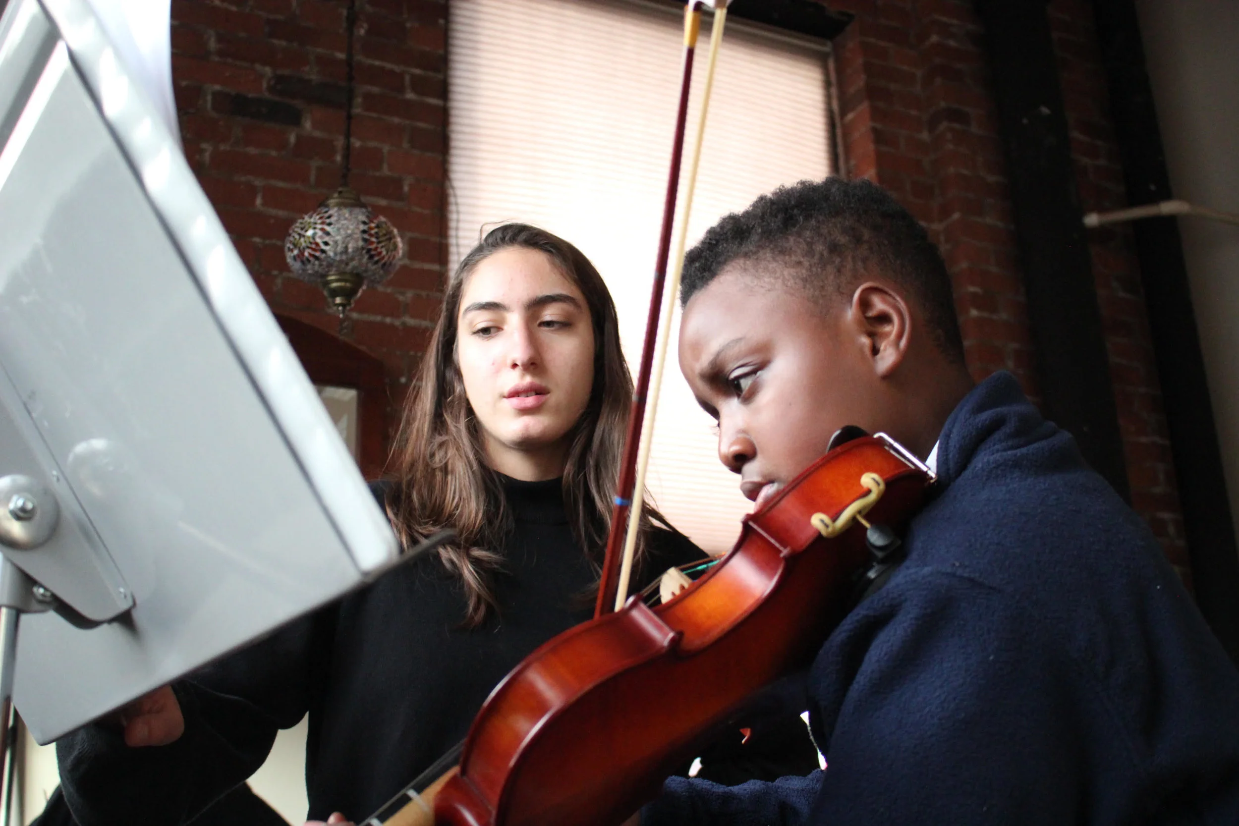 Music Haven senior, Audrey, practice buddying with D’Marcus