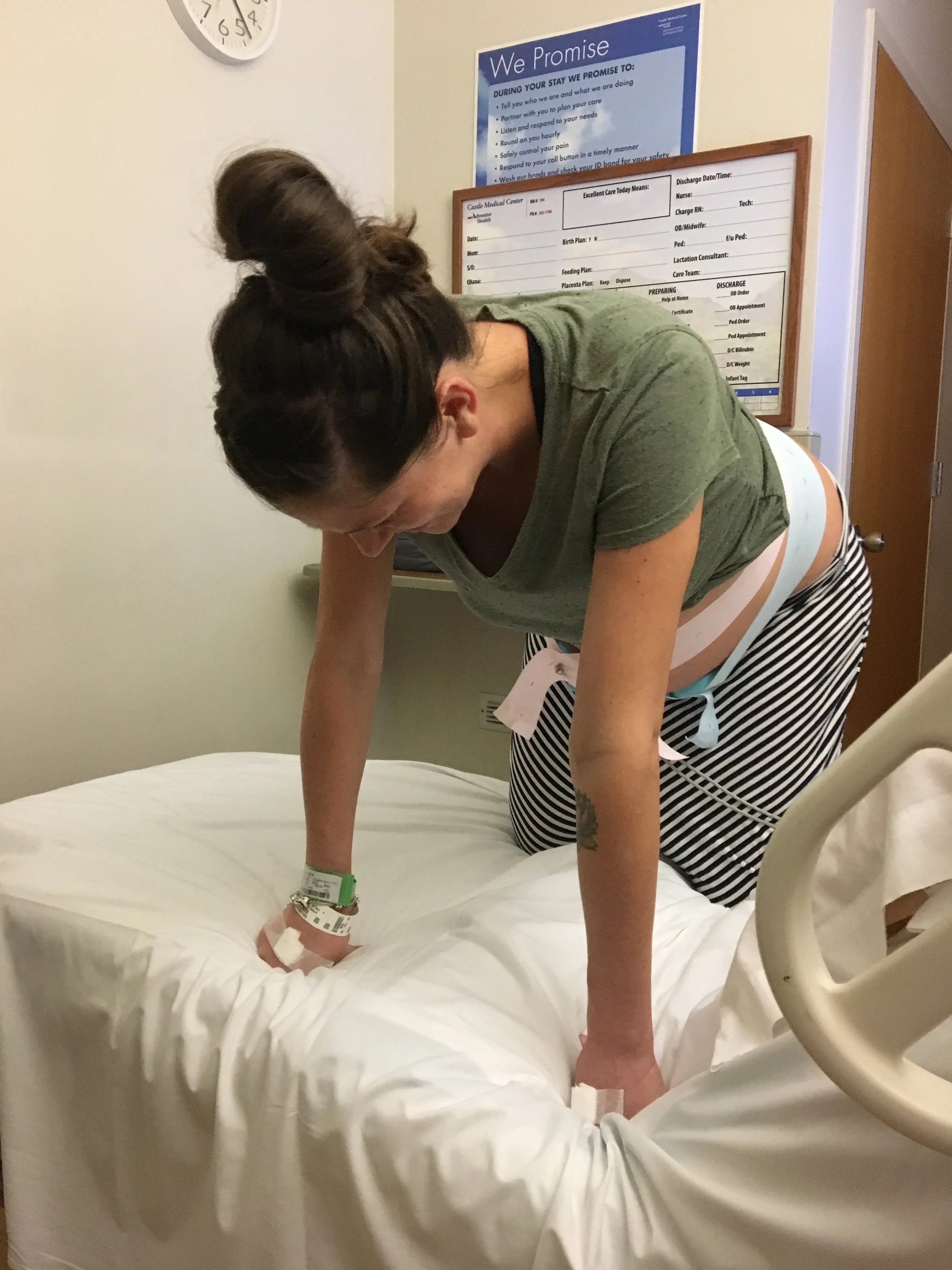 Being monitored while breathing through the early contractions. I hadn't been admitted yet. I can't tell if that's a smile or a 'holy crap this hurts' face.