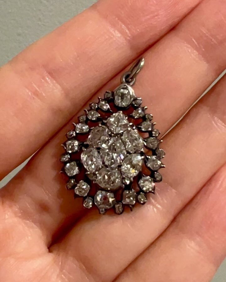 An antique diamond pendant, English, c. 1830, the pear shaped pendant with a central pave set diamond panel with an open border surround, mounted in silver and gold. Available $7,800 @simonteaklejewelry #georgianjewelry #georgianjewellery #antiquedia