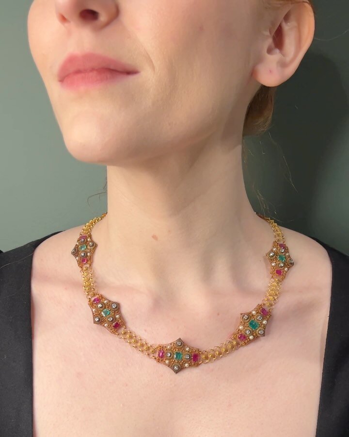 An antique gold and gem set necklace, circa 1830, designed as a series of eight cannetille panels set with emerald ruby diamond and pearls and fine open link intersections, in fitted case. Available @simonteaklejewelry #antiquenecklace #antiquejewelr