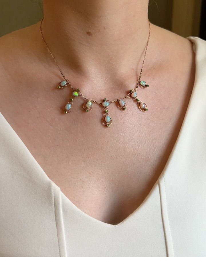 An antique opal and demantoid garnet fringe necklace, circa 1900, of open scroll design mounted in gold. Available $4,800 @simonteaklejewelry #artnouveaujewelry #artnouveaunecklace #antiqueopal #antiquenecklace #demantoidgarnet #simonteaklejewelry #s