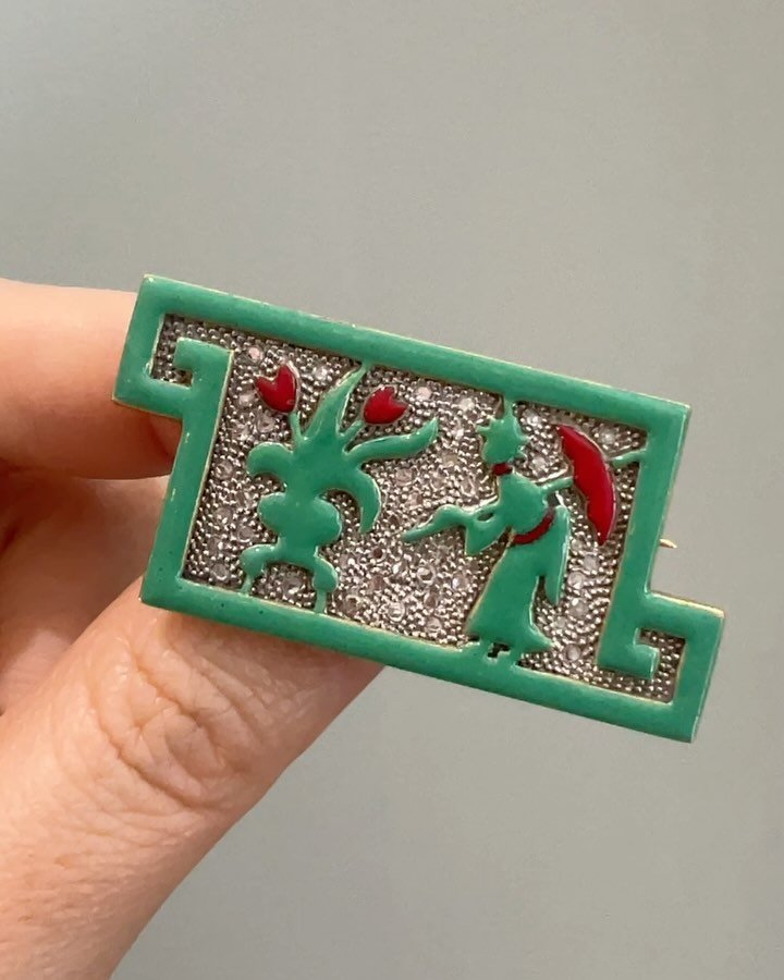 An Art Deco enamel and diamond brooch by Georges Fouquet, French, c. 1925, of geometric panel design depicting a floral and figurative motif in green and red enamel on a pave set rose cut diamond ground, mounted in gold and platinum. Available @simon