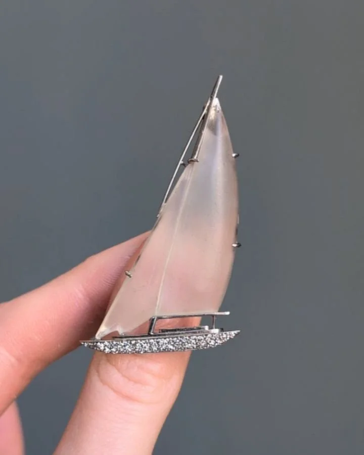 An Art Deco rock crystal and diamond yacht brooch, the frosted crystal sails with a pave set diamond hull, mounted in platinum. Circa 1925. Available $7,000 @simonteaklejewelry #artdecojewelry #artdecojewellery #artdecobrooch #artdecorockcrystal #art