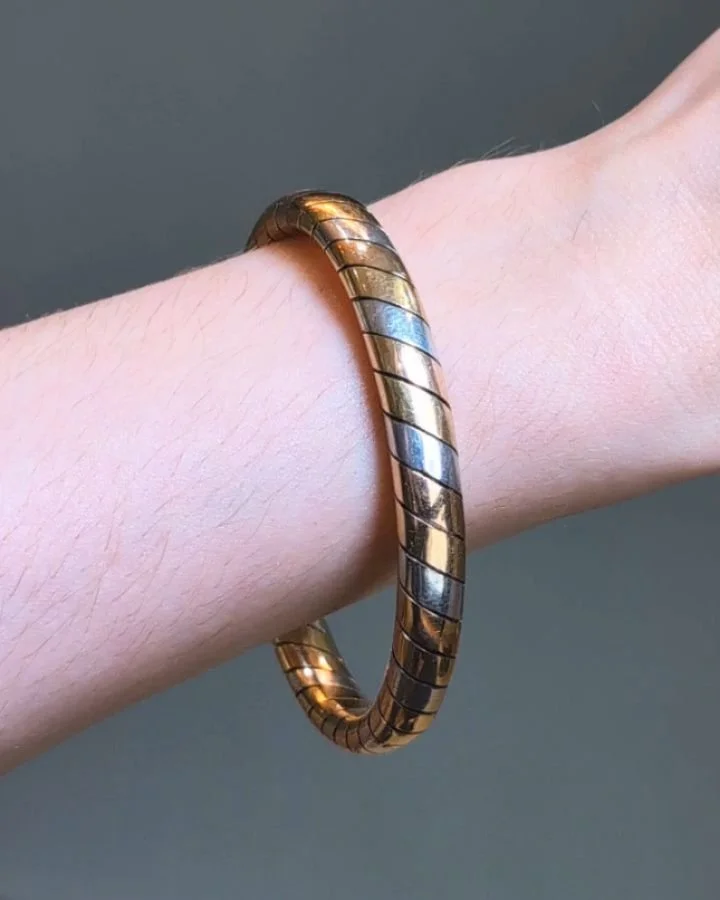 A tri-colored bangle by Van Cleef &amp; Arpels, spirally bound in 18kt yellow and rose gold and silver. Paris circa 1970. Available @simonteaklejewelry #vintagevcabracelet #vcajewelry #vcavintagejewelry #vcavintage #vintagevca #vintagevancleef #vancl
