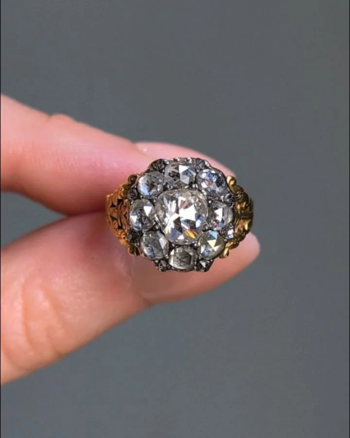 An antique rose cut diamond cluster ring, with scroll chased open shoulders, mounted in silver and gold. Circa 1835. Available @simonteaklejewelry #antiquediamondring #antiquediamond #diamondclusterring #antiquediamondclusterring #rosecutdiamond #ros