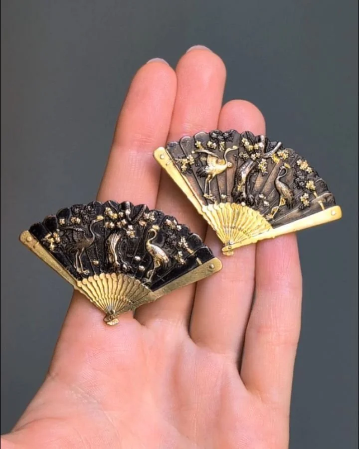 A pair of antique Shakudo earrings, of fan design depicting traditional Japanese motifs in gold, silver and bronze. Japanese circa 1880. Available @simonteaklejewelry #shakudojewelry #shakudojewellery #shakudobracelet #antiqueshakudo #simonteaklejewe