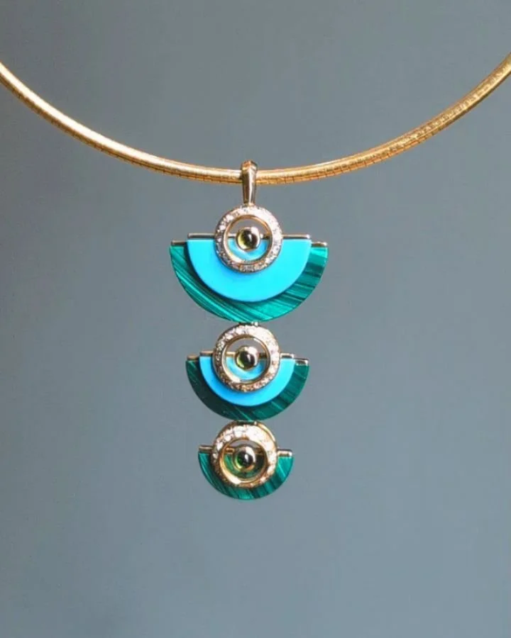 A carved turquoise and malachite 'Disc' necklace by Kia Schwan @kiaschwan, set in an 18k gold diamond and tourmaline mounting. Available @simonteaklejewelry #kiaschwan #kiaschwanjewelry #kiaschwannecklace #carvedstones #carvedstonenecklace #contempor