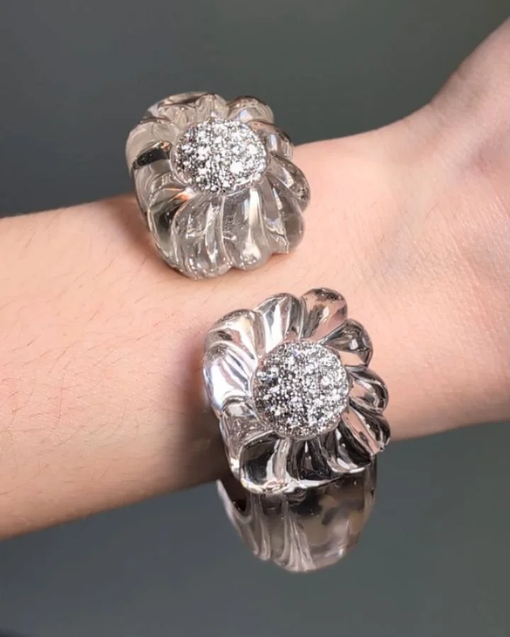 A rock crystal and diamond bangle by David Webb, the carved crystal bangle with cushion shaped fluted terminals inset with pave set diamond domes, mounted in 18kt white gold and platinum. New York circa 2000. Available @simonteaklejewelry #davidwebb 