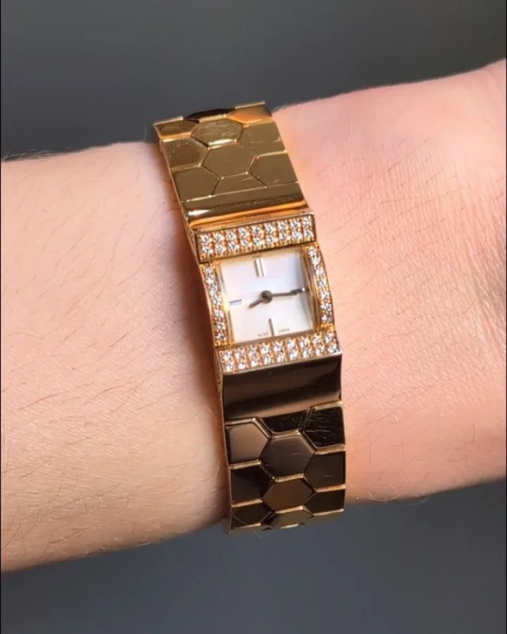 An 18kt gold &quot;Ludo&quot; watch by Van Cleef &amp; Arpels, the raised domed dial on an integral honeycomb band with circular cut diamond detail, in original box additional links and push piece. Paris circa 2000. Available @simonteaklejewelry #vca