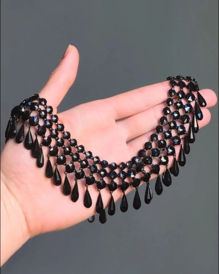 An antique jet collar necklace, designed as a three row circular cut jet band with a pear shaped jet fringe, mounted in iron. Circa 1870. Available @simonteaklejewelry #jetnecklace #antiquejet #antiquejetnecklace #antiquenecklace #antiquefringeneckla