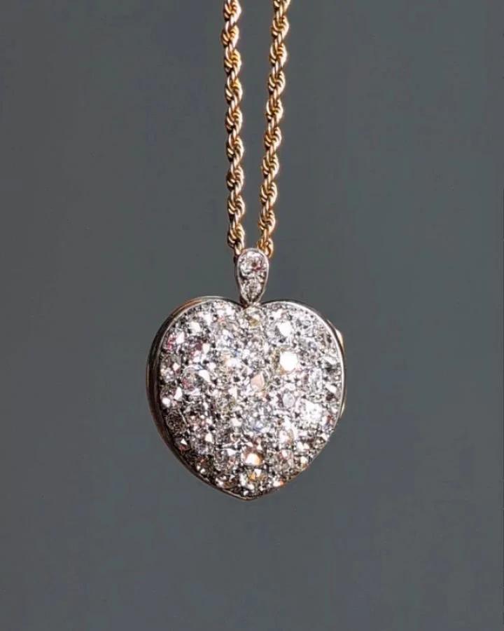 A pave set diamond heart pendant, with a hinged locket back, mounted in silver and gold, on a rope twist chain. Available @simonteaklejewelry #diamondpendant #diamondheart #heartlocket #diamondheartpendant #diamondlocket #simonteaklejewelry #simontea