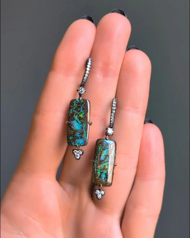 A pair of opal matrix and diamond earrings, each rectangular opal suspended from a diamond single line with single cut diamond trefoil terminal, mounted in silver and gold. Available @simonteaklejewelry #opalmatrix #opalearrings #opalmatrixearrings #
