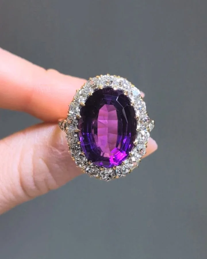 An antique amethyst and diamond cluster ring, the oval shaped amethyst with a diamond surround, mounted in gold. English circa 1890. Available @simomteaklejewelry #amethystring #antiqueamethystring #antiqueamethyst #amethystdiamondring #amethystclust