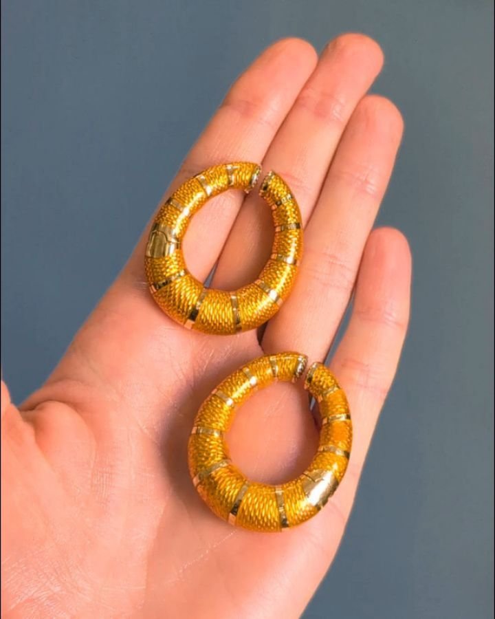 A pair of 18kt gold and enamel hoop earrings by Bulgari, the yellow-orange guilloche enamel hoops with spring hinge fitting. Circa 1980. Available @simonteaklejewelry&nbsp; #vintagebulgariearrings #bulgariearrings #bulgarijewelry #bulgarivintage #ena