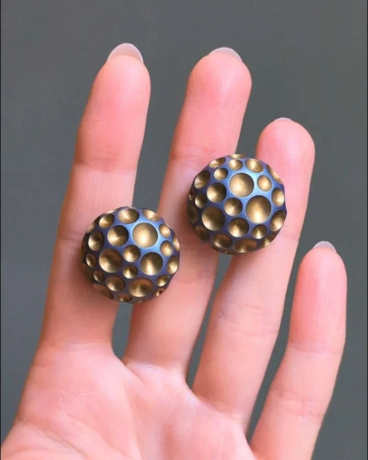 A pair of 18kt white gold and aluminum earrings by Hemmerle, of circular dimpled dome design with gold leaf inlay detail, in a fitted box. Available @simonteaklejewelry&nbsp; #hemmerle #hemmerleearrings #hemmerlejewelry #aluminumearrings #goldleaf #s