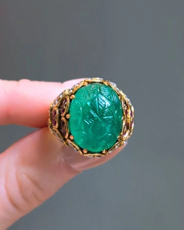 A carved emerald ruby and diamond cocktail ring, the oval emerald in a raised setting with circular cut ruby and diamond detail, mounted in 18kt gold. Circa 1965. Available @simomteaklejewelry #bulgari #bulgarijewelry #bulgariring $vintagebulgari #vi