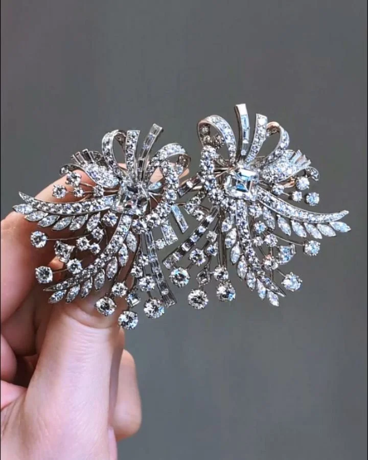 A diamond double clip brooch by Raymond Yard, each of vari cut open ribbon spray design with a central trapezoid cut diamond, mounted in platinum. Circa 1956.. Available @simonteaklejewelry #raymondcyard #raymondyard #raymondyardjewelry #raymondyardb