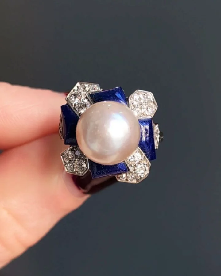 An Art Deco natural pearl and diamond ring, the central pearl with a pave set diamond and lapis lazuli pin wheel surround mounted in platinum. Paris circa 1920. Available @simomteaklejewelry #artdeco #artdecojewelry #artdecoring #artdecopearl #natura