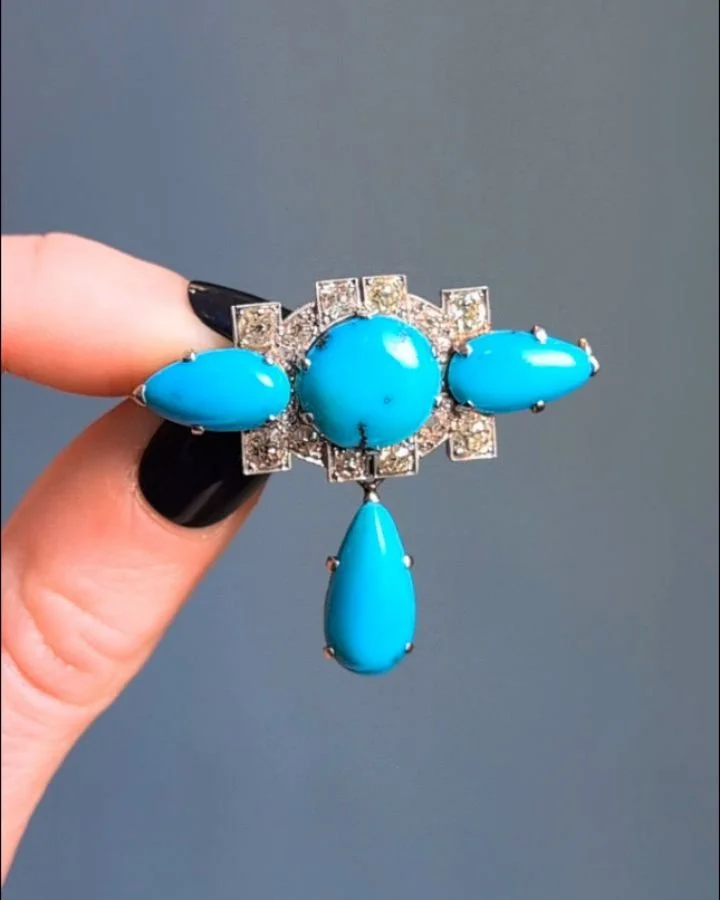 An Art Deco turquoise and diamond brooch, the central circular turquoise within a diamond set geometric panel and pear shaped turquoise shoulders and detachable turquoise drop, mounted in platinum, in fitted case. Circa 1920. Available @simonteakleje