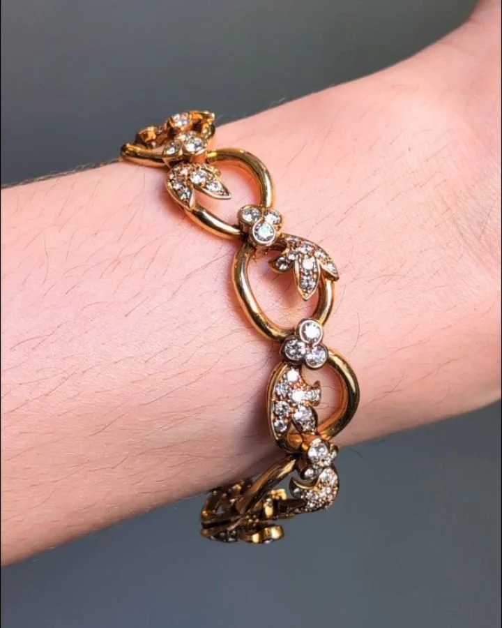 An 18kt gold and diamond bracelet by Chaumet, the open oval gold links with applied pave set diamond foliate and trefoil motifs. Paris circa 1970. Available @simonteaklejewelry #chaumet #chaumetjewelry #vintagechaumet #chaumetbracelet #simonteakle #s