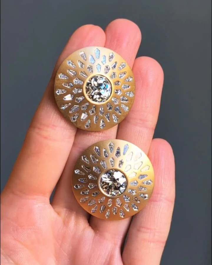A pair of diamond earrings, each of circular form with a central old european cut diamond and kite shaped diamond scattered surround, mounted in 18kt matte gold. Available @simonteaklejewelry #diamondearrings #oldeurodiamond #oldeuropeandiamond #olde