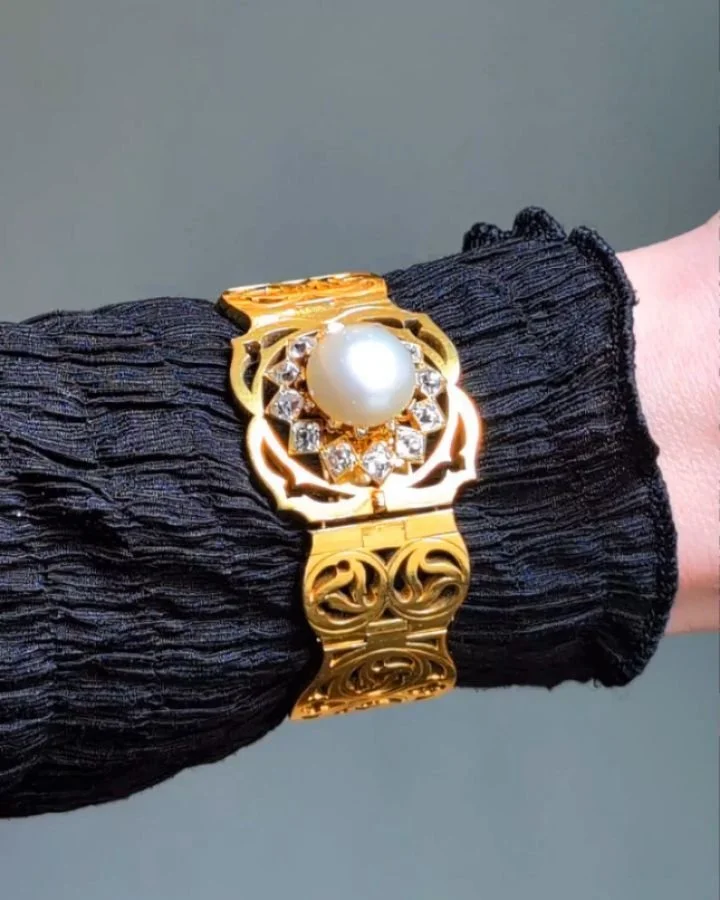 An antique pearl diamond and gold gothic revival bracelet, the open articulated scroll panel links on a panel clasp set with a central button pearl with an old mine cut diamond surround. Circa 1860. Available @simonteaklejewelry Available @simonteakl