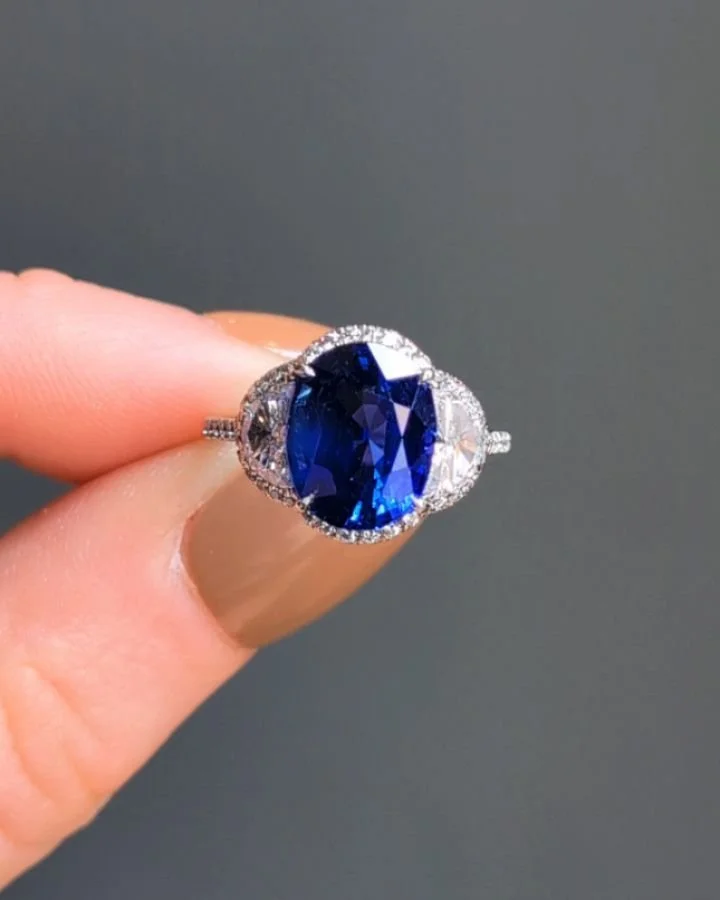 An oval cut 5.20cts sapphire and diamond ring, the central sapphire with half moon cut diamond shoulders within a micro pave diamond platinum mount. Available @simomteaklejewelry #sapphirering #madagascarsapphire #noheatsapphire #sapphirediamondring 