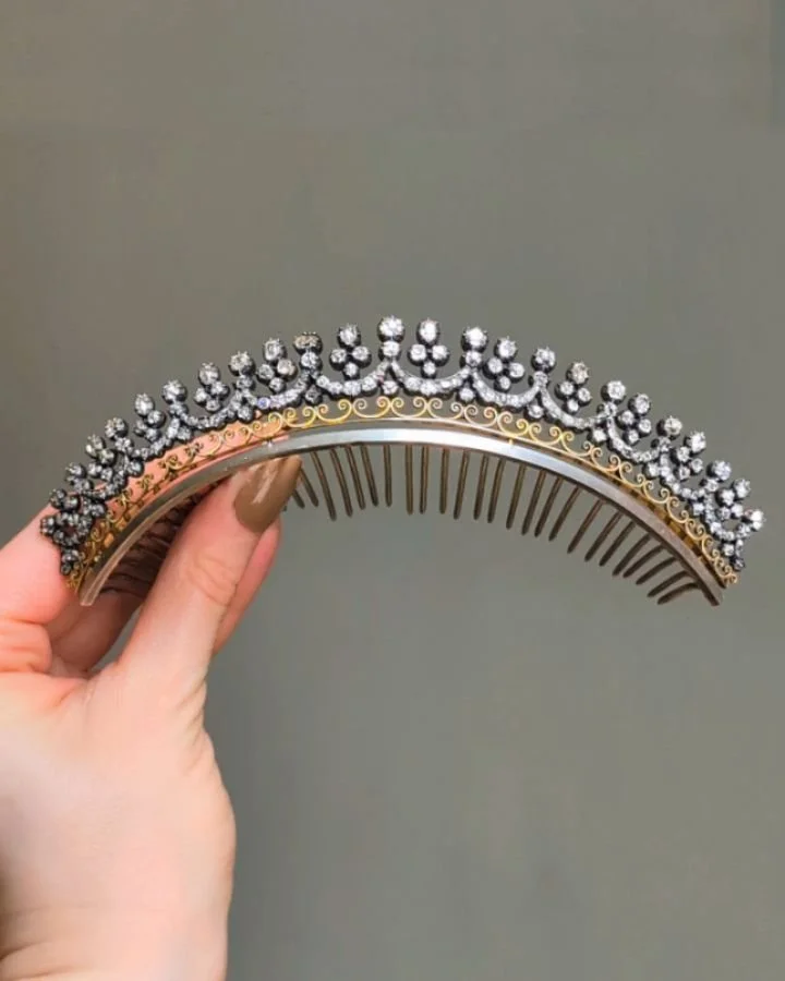 An antique diamond diadem, designed as a series of running festoons with diamond collet detail above gold scroll motifs mounted in silver and gold with silver comb fitting. French circa 1860. Available @simonteaklejewelry #antiquetiara #antiquediadem