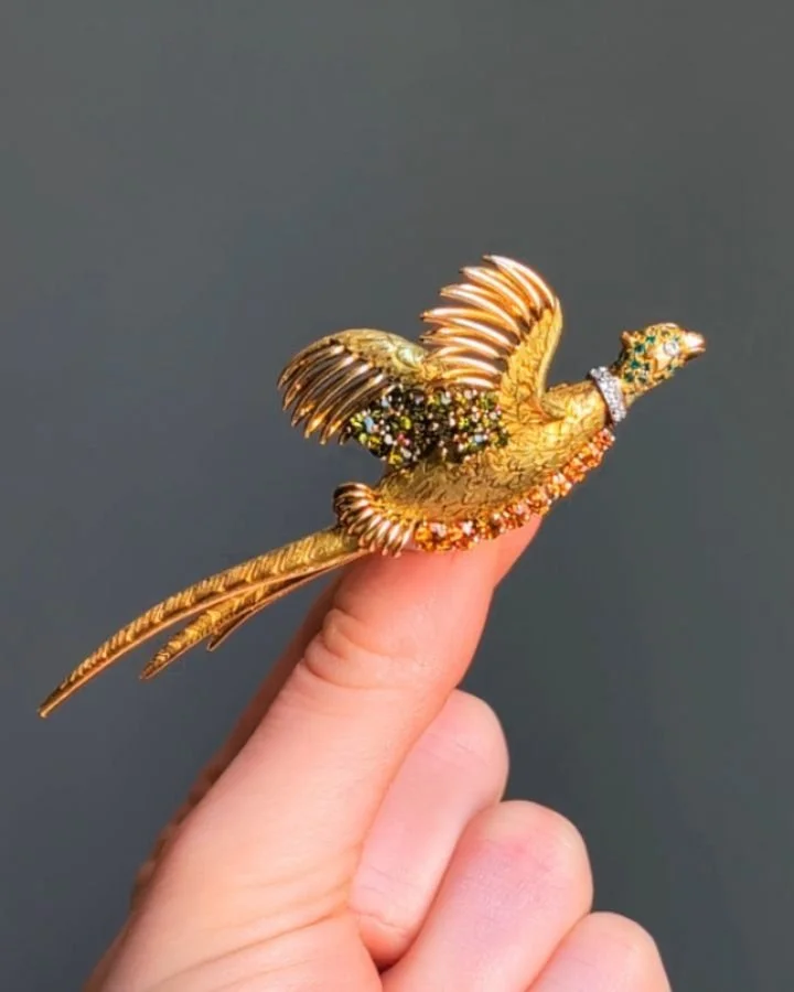 An 18kt gold and gem set Pheasant brooch by Herm&egrave;s, in flight with circular cut citrine, chrysoberyl, emerald and diamond detail. Paris circa 1965. Available @simonteaklejewelry #hermesbrooch #hermes #hermesjewelry #vintagehermes #vintageherme