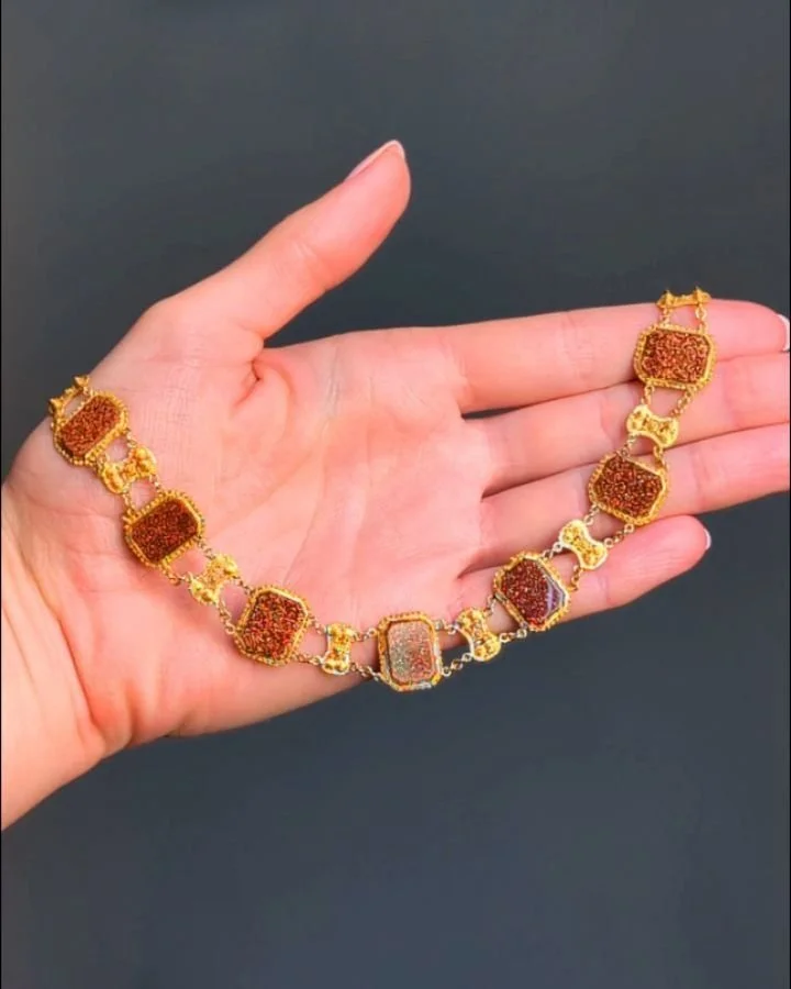 An antique goldstone necklace, designed as a series of rectangular goldstone panels each within a canetille frame and filigree spacers, mounted in 18kt gold. English circa 1820. Available $5,800 @simonteaklejewelry #antiquejewelry #antiquejewellery #
