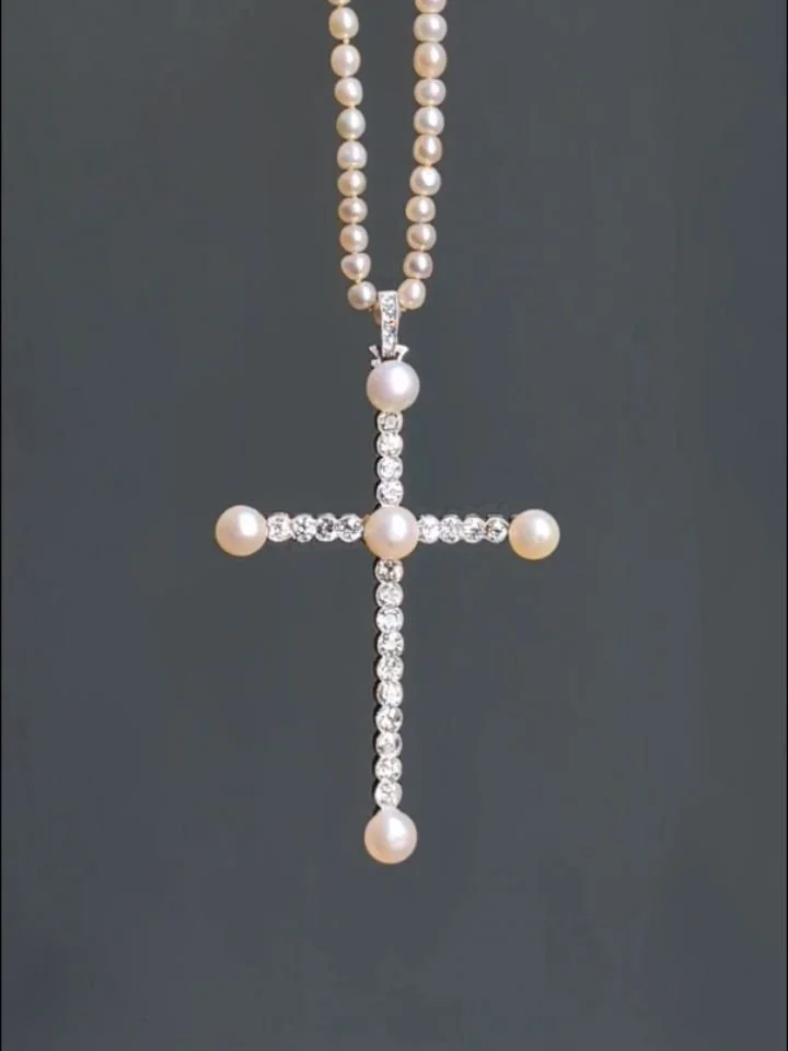 A Belle &Eacute;poque pearl and diamond cross pendant the fine old European-cut cross with natural pearl button center and terminals mounted in platinum, on a single strand natural pearl long chain. Circa 1910. Available @simonteaklejewelry #antiquej