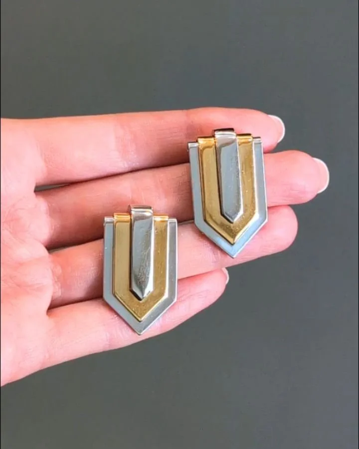 A pair of 18kt gold and platinum clip brooches by Hemmerle, each of stylised shield design. Circa 1985. Available @simonteaklejewelry #hemmerle #vintagehemmerle #hemmerlebrooches #vintagehemmerlebrooches #goldandplatinumbrooches #hemmerlejewelry #sim