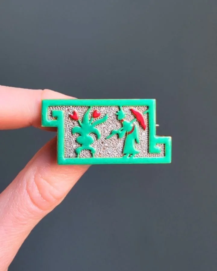An Art Deco enamel and diamond brooch by Georges Fouquet, of geometric panel design depicting a floral and figurative motif in green and red enamel on a pave set rose cut diamond ground, mounted in gold and platinum. French circa 1925. Available @sim