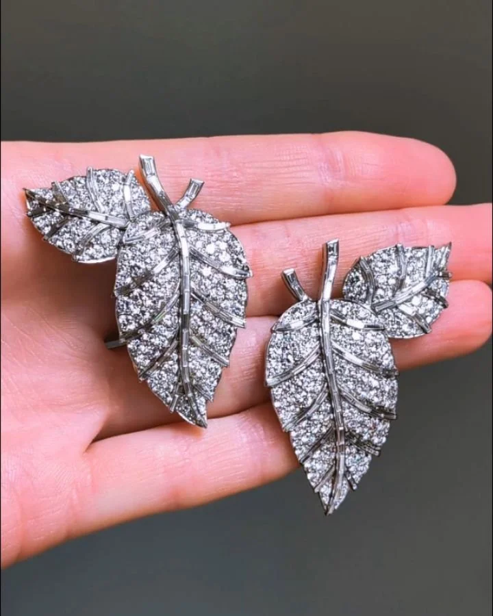 A pair of diamond brooches by Raymond Yard, each twin leaf spray with pave set diamonds and baguette cut diamond stems and veins. New York circa 1953, The Woolworth Family. Available @simonteaklejewelry #raymondcyard #raymondyard #raymondyardjewelry 