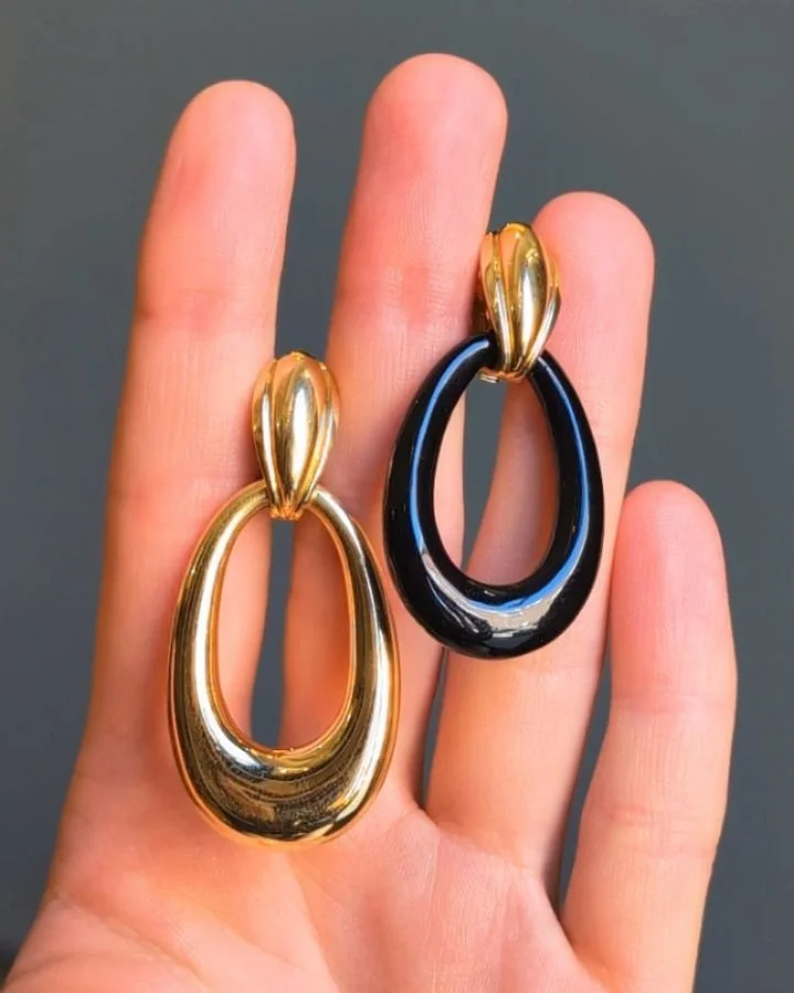 A pair of 18kt gold earrings by Georges Lenfant for Cartier, each designed with a detachable open pear shaped gold drop, with additional pairs of black onyx, white onyx, lapis lazuli, malachite, tiger's eye and frosted crystal drops. Paris circa 1975