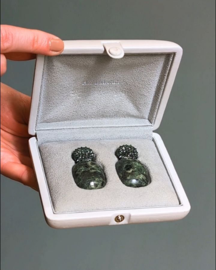 A&nbsp;pair of sapphire and jasper earrings by Hemmerle, each designed with a pave bombe top set with inverted green sapphires suspending a cabochon mottled green jasper panel, mounted in 18kt white gold and silver, in fitted case. Available @simonte
