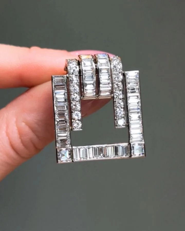 An Art Deco diamond clip brooch by Van Cleef &amp; Arpels, the circular and baguette cut diamonds in stylized buckle form, mounted in platinum. Paris circa 1930. Available @simonteaklejewelry #vancleefarpels #vancleefandarpels #vintagevca #vintagevan
