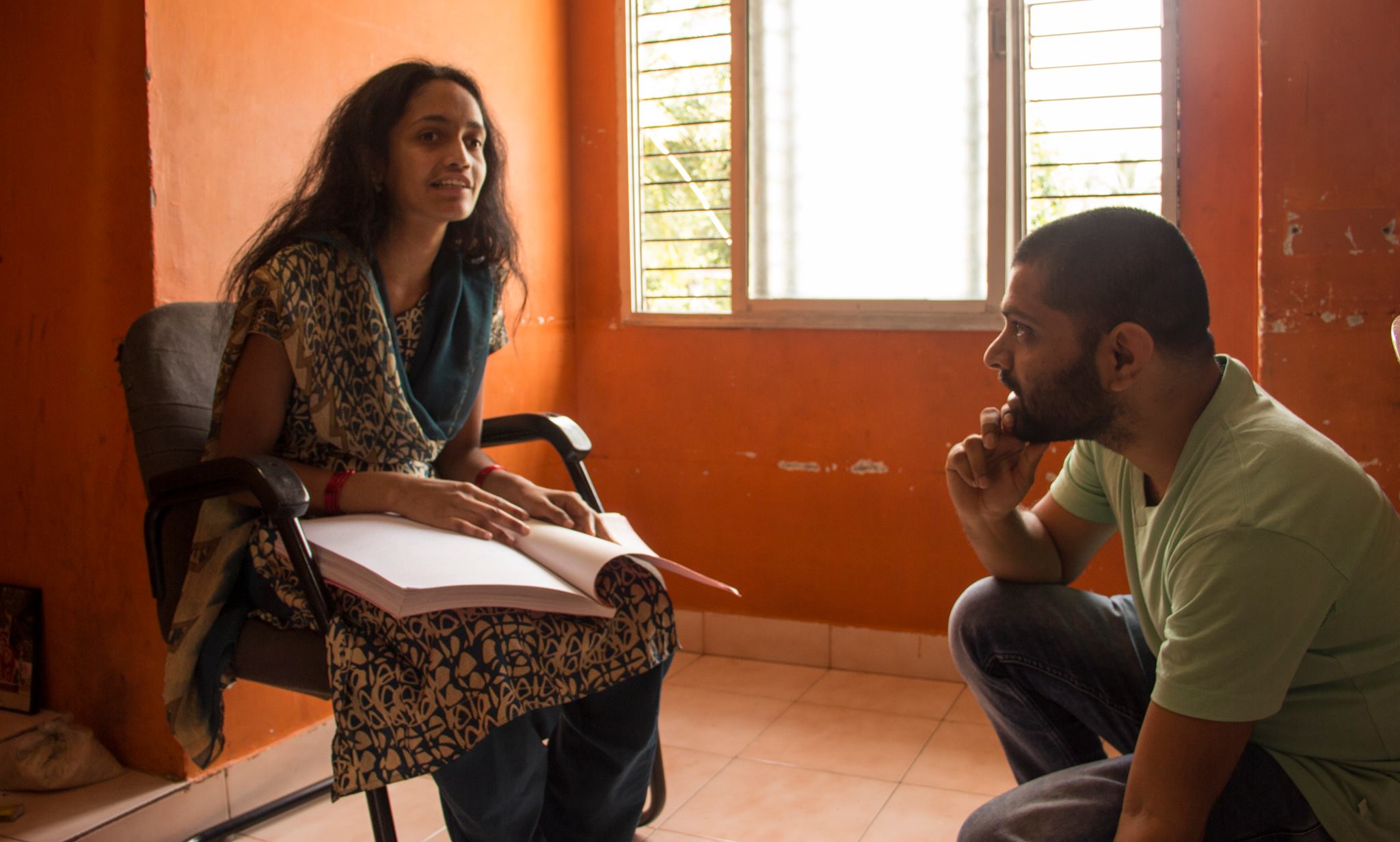 A bright student describing Braille to Rakesh 