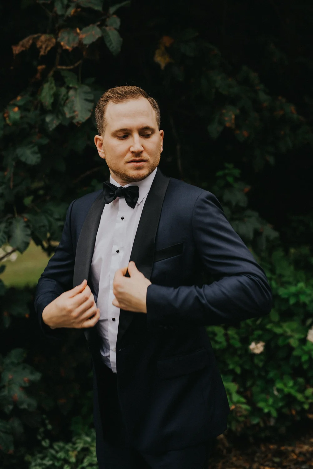 Custom midnight shawl-lapel tuxedo with bow tie by Atelier Suiting