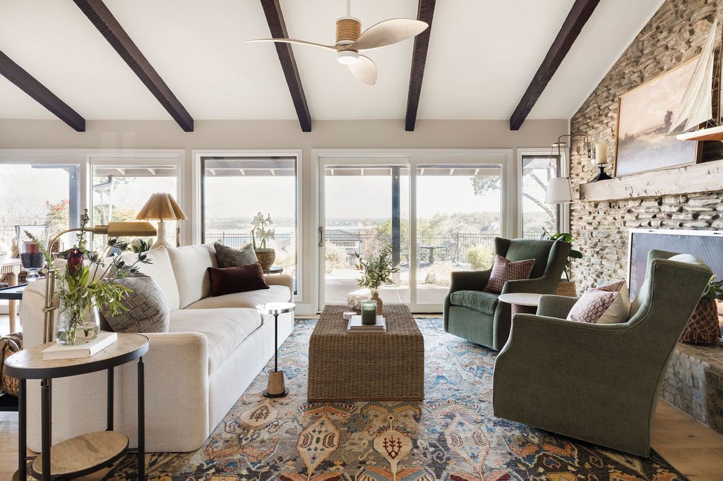 Thanks to all the recent rain, Lake Travis is back up to 90% capacity&mdash;and the views from this living room just got even better.

We designed this space to take full advantage of that lakefront view, with big windows, cozy layers, and seating th