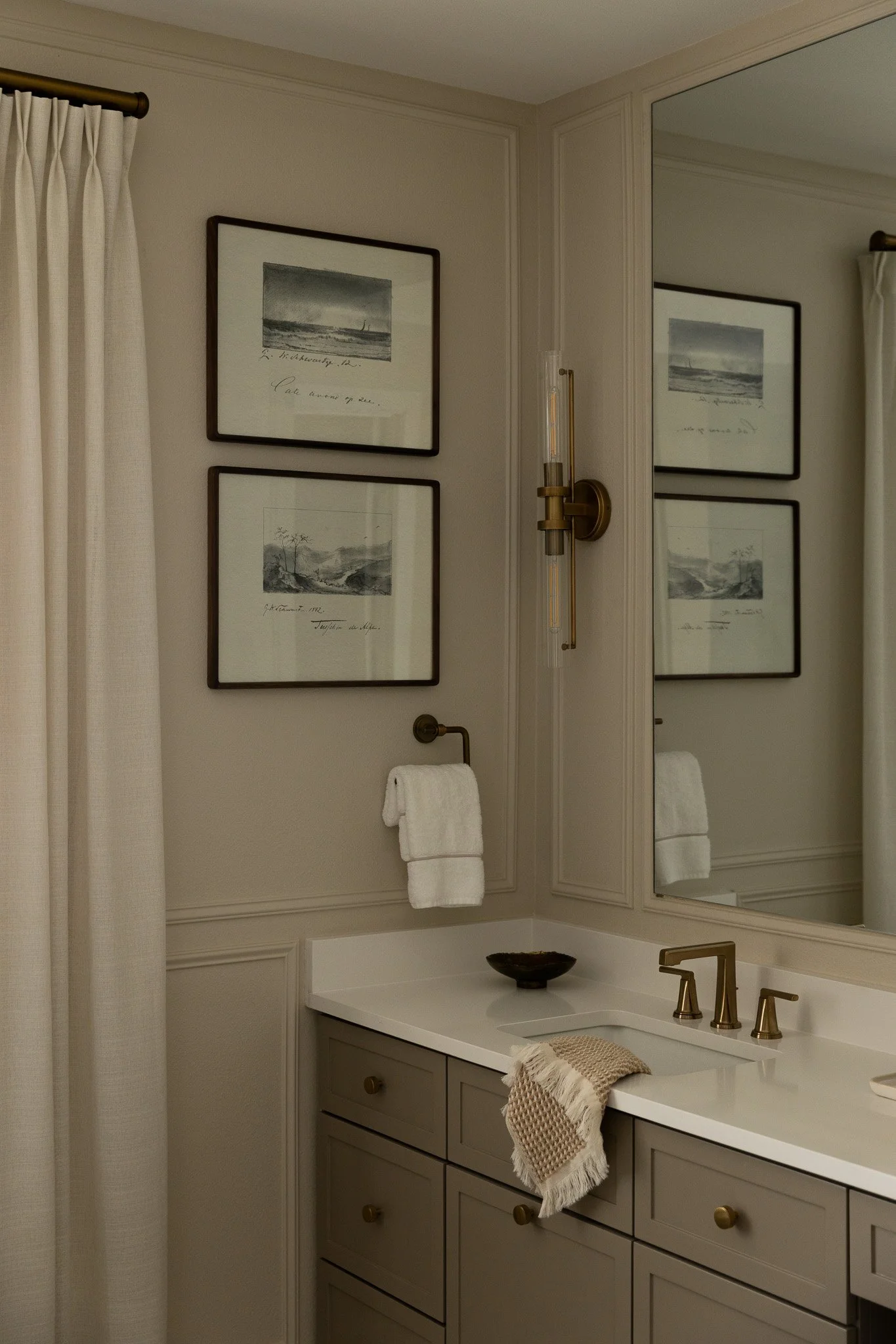 An elegant and sophisticated bathroom design with taupe cabinetry, romantic details and serene luxury feel.