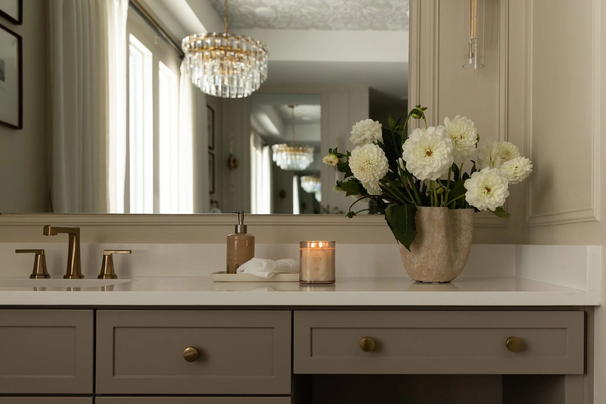 An elegant and sophisticated bathroom design with taupe cabinetry, romantic details and serene luxury feel.