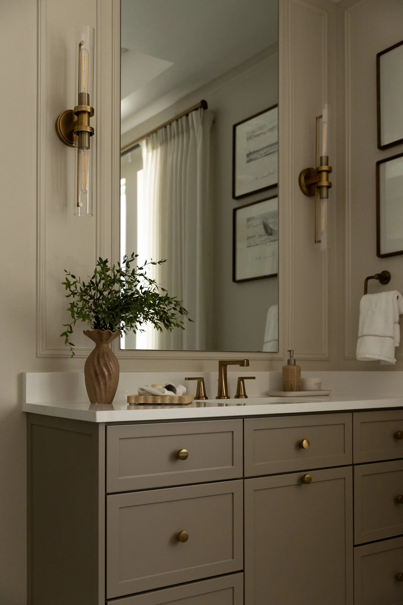 An elegant and sophisticated bathroom design with taupe cabinetry, romantic details and serene luxury feel.