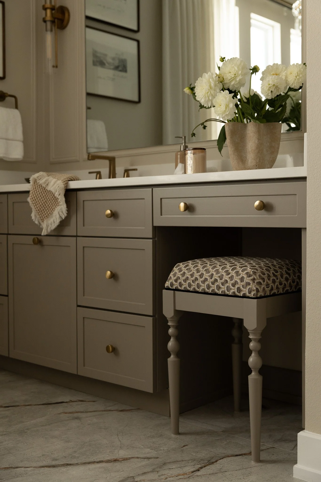 An elegant and sophisticated bathroom design with taupe cabinetry, romantic details and serene luxury feel.